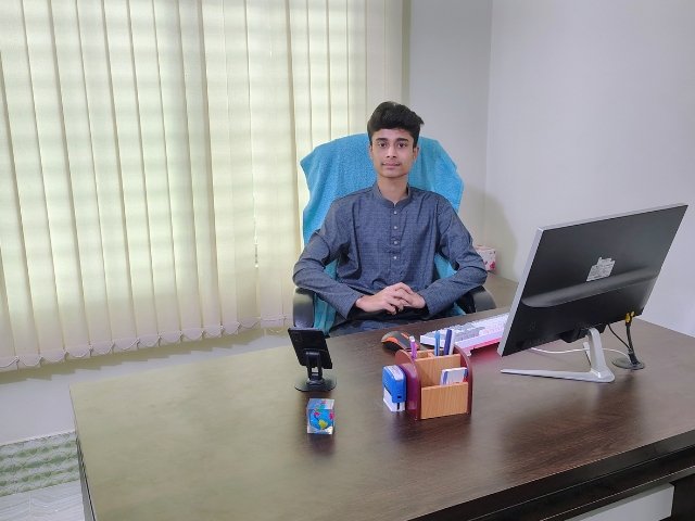 Business leader and CEO in office, focused on work at a modern desk.